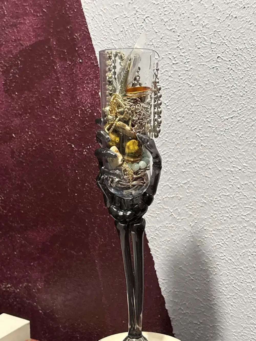 Trick or treat yourself to a skeleton hand on a flute full of jewelry